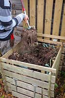 Turning over a compost heap with a fork