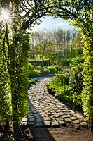 Archway to formal garden in spring. Laura Dingemans garden, April.