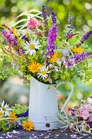 Jug of wildflowers. Leucanthemum, Salvia, Scabiosa, Rumex, Galium verum, yellow ox eye, Silene vulgaris - Bladder campion, purple loosestrife.