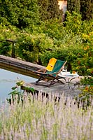 Deckchair by pond - Beretta Kastner architetti. Monza. Italy
