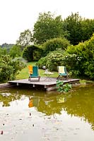 Deckchairs by pond - Beretta Kastner architetti. Monza. Italy