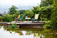 Deckchairs by pond - Beretta Kastner architetti. Monza. Italy
