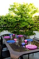 Acer Jap. Vitifulium and trellis with table on terrace, Milan, Italy 