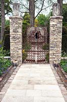 Stone gateway and path leading to focal point sculpture, Brewin Dolphin Garden, RHS Chelsea 2012, May.