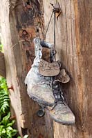 Soldiers discarded boots hanging from wooden beams of watch tower, 'Quite Time' in DMZ Forbidden Garden, RHS Chelsea, 2012.
