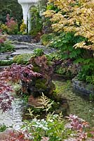 Garden with water feature, pond, and ornamental trees including Acers, inspired by Kazuyuki Ishihara, RHS Chelsea 2012, May.