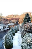 Gardens of Brig O' Doon House Hotel with line of clipped Leylandii trees, Burns National Heritage Park, Alloway, Ayr, Scotland, January.