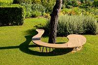Curved wooden bench in Project garden, Macerata, Italy, June.