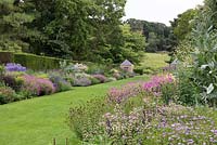 View down Newby Hall's double herbaceous border to River Ure. Seen over froth of erigeron, astrantia, sanguisorba and hardy geranium.