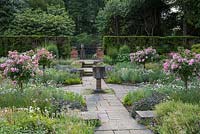 Sylvia's Garden at Newby Hall, a sunken, formal layout of beds with Byzantine stone corngrinder.