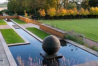 Long terrace rill ending in pool with slate sphere water feature created by sculptor James Parker.