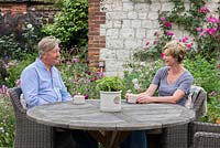 Malcolm and Claudia Starr relax in the garden they started creating in 2012.