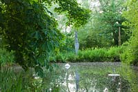 Pond with modern sculpture - Asthall Manor, Oxfordshire