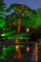 Water terrace and tree lit up at night, Blenheim Palace, Oxfordshire, November. 