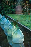 Glass bottles in rill, Clos du Peyronnet, Menton, France.