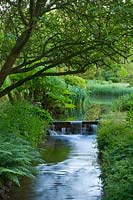 Stream and weir at Little Ponton Hall, Lincolnshire, June.