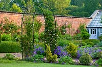 Metal arch in walled garden at Little Ponton Hall, Lincolnshire, June.