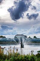 Fountain, lake and victorian palm house in Autumn - Royal Botanic Gardens, Kew