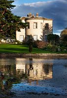 Thorp Perrow Arboretum in Yorkshire - View across the lake to the house in Autumn