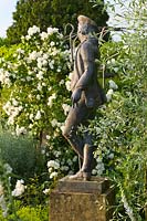 Statue in White Garden with white flowers of Philadelphus 