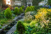 Rill and green border - Alchemilla, Brunnera 'Jack Frost', Berberis 'Aurea Nana', Rose 'Princess Diana' and Alliums and West facade of Eastleach House