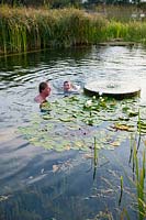 Man and boy swim in the 'natural' swimming pool