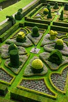 View over formal parterre showing clipped and shaped topiary and hedging
