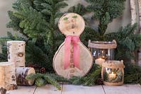 Birch wood snowman in rustic festive scene