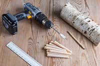 Equipment and materials required to make Birch candle holder. Including cordless drill, ruler, pencil, beeswax candles and sawn birch wood.
