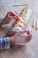 Close up detail showing the securing of beeswaxcandles using hot wax
