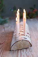 Lit Birch wood candle holder with beeswax candles