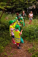 Preschool group of 4 year olds collecting different leaf shapes in Holbrook Garden, Devon