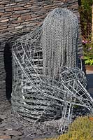 A metal sculpture of a crouching figure in the Reachout garden Designer: John Everiss Sponsors: CSH Transport, Together Housing