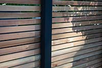 Contemporary louvred wooden garden fence