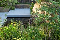Sunken terrace and pool in grey sandstone. The M and G Garden, RHS Chelsea Flower Show 2016. Designer Cleve West. Gold Medal winner