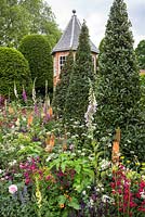 Twirling bay trees in The Harrods British Eccentrics Garden, RHS Chelsea Flower Show 2016. Designer Diarmuid Gavin.