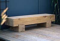 Contemporary oak wood minimalist garden bench seat. Lengths of dressed oak with block feet. RHS Hampton Court Flower Show