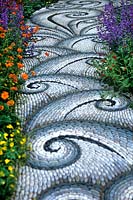 Patterned pebble path with perennial planting to either side Life Garden Cancer Research UK Chelsea 2004