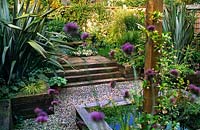 Patio garden with raised bed pool gravel paths architectural planting railway sleeper steps