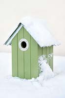 Bird house covered with snow