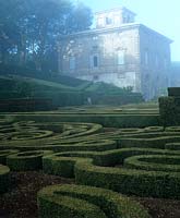View of house over boxwood maze at Villa Lante Italy