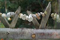 Rustic chestnut wooden fence with garden behind