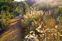 Cambo Walled garden, Fife, Scotland, UK, autumn, pathway, border, drift planting, ornamental grass, arch,