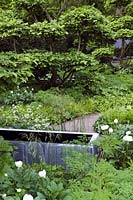 Laurent Perrier Chelsea Tom Stuart Smith 2008 show garden with paving, cloud pruned hornbeam, zinc water tanks & perennial plant