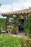 The Flower House covered with climbing roses at Borgo Santo Pietro, Tuscany.