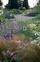 Dry summer perennial bed with gravel pathways at Beth Chattos garden at Elmstead Essex
