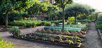 Hatfield House potager garden showing raised beds with protective wicker basket cloches, paths, fruit trees