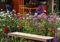 Perennial garden with colorful garden furniture