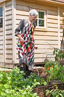 Lady is watering the vegetable garden