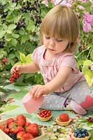 Little girl with red currants